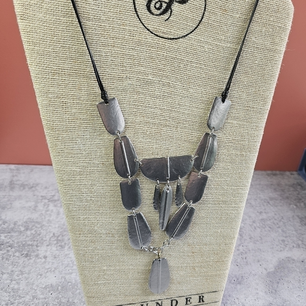 Chico’s black necklace with heavy silver Aztec design